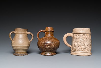 A German stoneware mug and two jugs, Raeren and Cologne, 16/17th C.