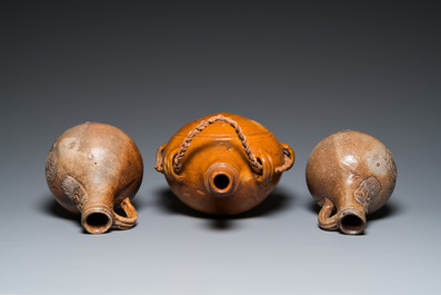 Two German stoneware bellarmine jugs and a pilgrim's flask, 17th C.