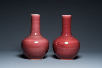 A pair of Chinese monochrome peachbloom-glazed bottle vases, 19th C.