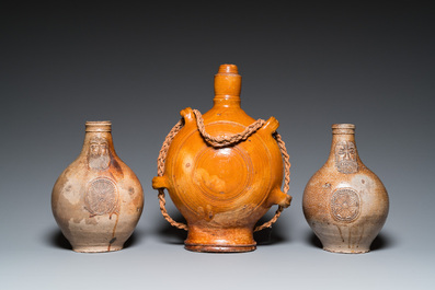 Two German stoneware bellarmine jugs and a pilgrim's flask, 17th C.