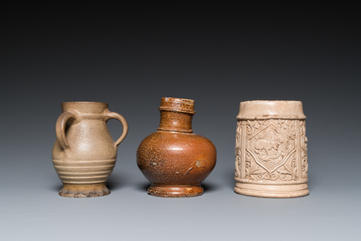 A German stoneware mug and two jugs, Raeren and Cologne, 16/17th C.