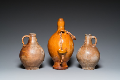 Two German stoneware bellarmine jugs and a pilgrim's flask, 17th C.