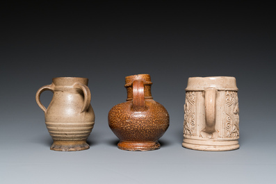 A German stoneware mug and two jugs, Raeren and Cologne, 16/17th C.