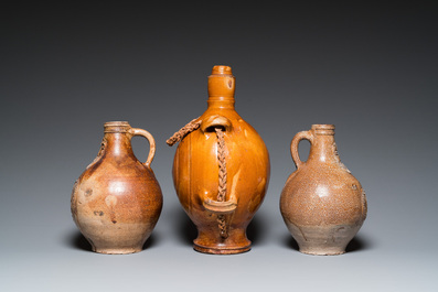 Two German stoneware bellarmine jugs and a pilgrim's flask, 17th C.