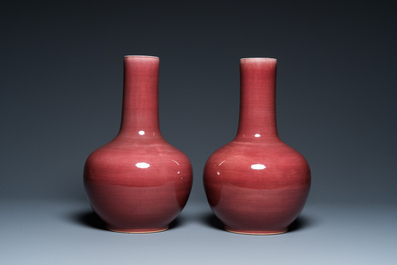 A pair of Chinese monochrome peachbloom-glazed bottle vases, 19th C.