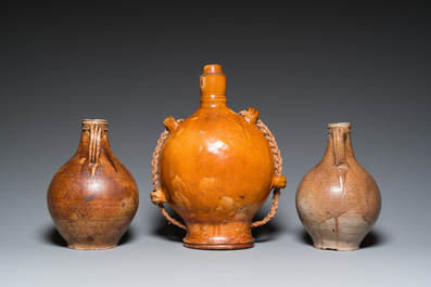 Two German stoneware bellarmine jugs and a pilgrim's flask, 17th C.