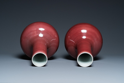 A pair of Chinese monochrome peachbloom-glazed bottle vases, 19th C.