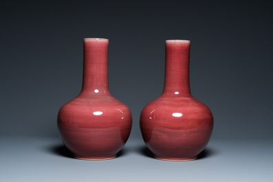 A pair of Chinese monochrome peachbloom-glazed bottle vases, 19th C.