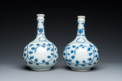 A pair of Chinese blue and white 'peony scroll' pharmacy bottles, Kangxi