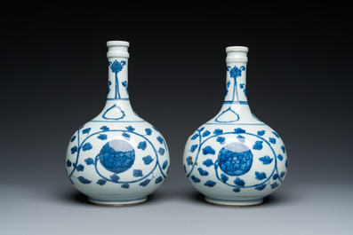 A pair of Chinese blue and white 'peony scroll' pharmacy bottles, Kangxi