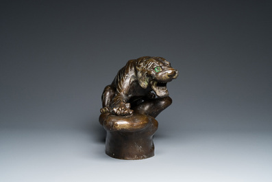 A large Vietnamese bronze tiger on a carved wooden stand, 19/20th C.