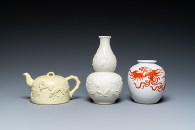 A Chinese yellow-glazed biscuit teapot, a white-glazed biscuit double gourd vase and an iron-red 'phoenix' jar, 20th C.