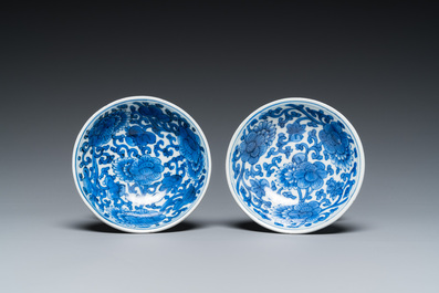 A pair of Chinese blue and white 'lotus scroll' stem cups, Kangxi