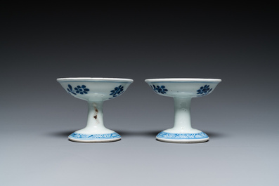 A pair of Chinese blue and white 'lotus scroll' stem cups, Kangxi