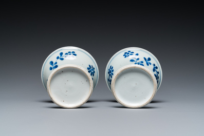 A pair of Chinese blue and white 'lotus scroll' stem cups, Kangxi