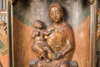 A large Spanish gilt and polychromed wooden tryptich retable with Saint John the Baptist, the Virgin Mary and Saint Roch, 1st half 16th C.