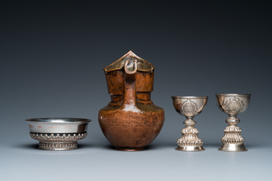 Two Tibetan silver stem bowls, a silvered bowl and a copper 'sengmaohu' ewer, 17/19th C.