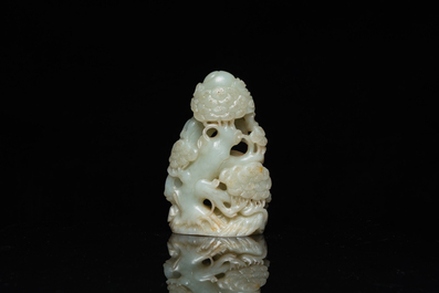 A Chinese celadon and russet jade ram sculpture on wooden stand, 19th C.