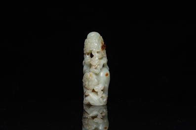 A Chinese celadon and russet jade ram sculpture on wooden stand, 19th C.