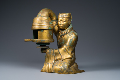 A large Chinese gilt bronze oil lamp in the shape of a kneeling figure, after a Han Dynasty example