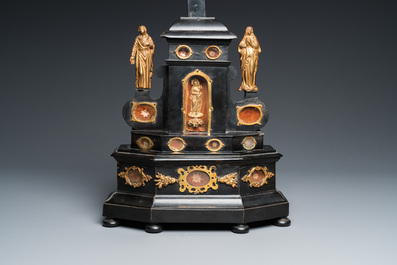 An ebonised wooden reliquary crucifix with gilt bronze corpus, Germany or Italy, 17/18th C.