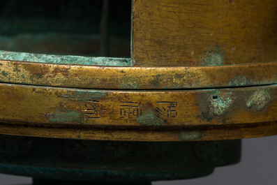 A large Chinese gilt bronze oil lamp in the shape of a kneeling figure, after a Han Dynasty example