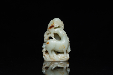 A Chinese celadon and russet jade ram sculpture on wooden stand, 19th C.