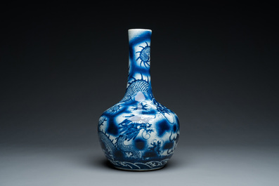 A Chinese blue and white 'dragons' bottle vase, 19th C.