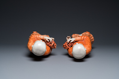 A pair of Chinese coral red 'Hehe Er Xian' sculptures, probably Jiaqing