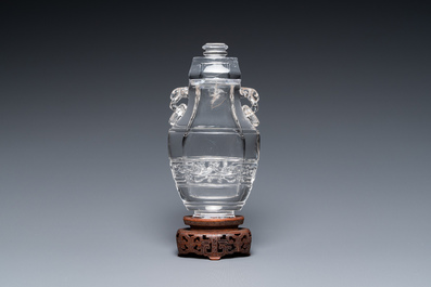 A Chinese rock crystal covered vase on wooden stand, 19/20th C.