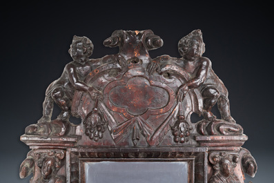 A carved oak mirror with cherubs and caryatids, the Low Countries, 17th C.