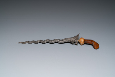 An Indonesian 'kris' or 'keris' dagger in polished Javanese wood with gilt copper and precious stones, 19th C.