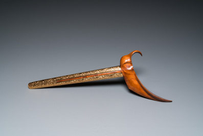 An Indonesian 'kris' or 'keris' dagger in polished Javanese wood with gilt copper and precious stones, 19th C.