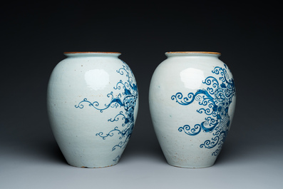 A pair of Dutch Delft blue and white tobacco jars with brass lids, 18th C.