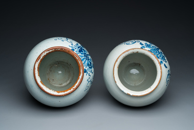 A pair of Dutch Delft blue and white tobacco jars with brass lids, 18th C.