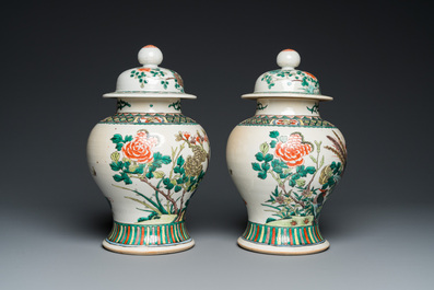 A pair of Chinese Nanking famille verte vases and covers, 19th C.