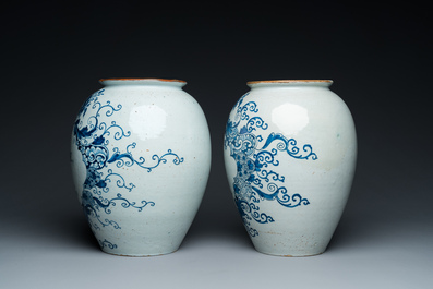 A pair of Dutch Delft blue and white tobacco jars with brass lids, 18th C.