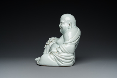 A Chinese blanc de Chine Buddha on lacquered and gilded wooden 'lotus' stand, Qianlong/Jiaqing