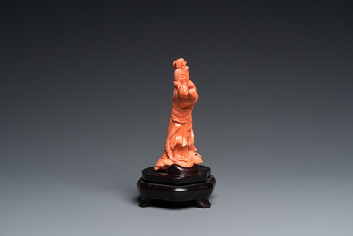 A Chinese red coral carving of Guanyin with a fan, 19/20th C.
