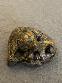 A Chinese gilt bronze &lsquo;dog&rsquo; scroll weight, Ming