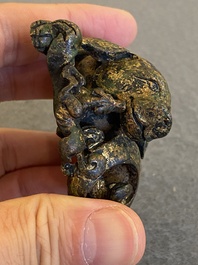 A Chinese gilt bronze &lsquo;dog&rsquo; scroll weight, Ming