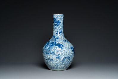 A Chinese blue and white 'dragons' bottle vase, 19th C.