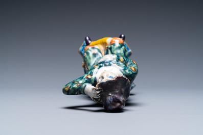 A polychrome Dutch Delft figure of a seated man and a blue and white one of a seated lady, 18th C.