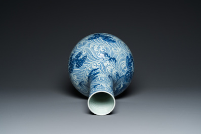 A Chinese blue and white 'dragons' bottle vase, 19th C.