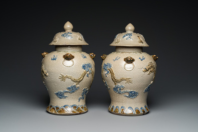 A pair of Vietnamese Bat Trang stoneware 'dragon' vases and covers, 19th C.
