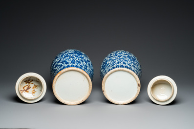 A pair of Chinese blue and white covered vases with floral sprigs, 19th C.