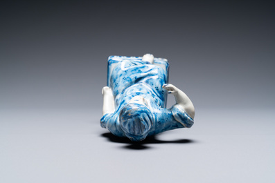 A polychrome Dutch Delft figure of a seated man and a blue and white one of a seated lady, 18th C.
