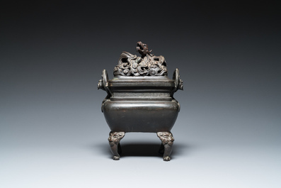 Een Chinese bronzen wierookbrander met opengewerkt 'draken' deksel op bronzen sokkel, 17e eeuw