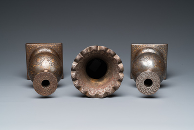 A pair of Qajar damascened candlesticks and a vase, Persia, 19th C.