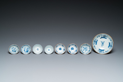 Eleven Chinese blue and white saucers, seven cups and a bowl, Kangxi/Qianlong